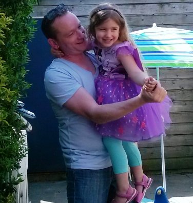 De trotse vader Jeffrey met zijn jarige dochter. Ze draagt een jurkje met vleugels uit My Little Pony.